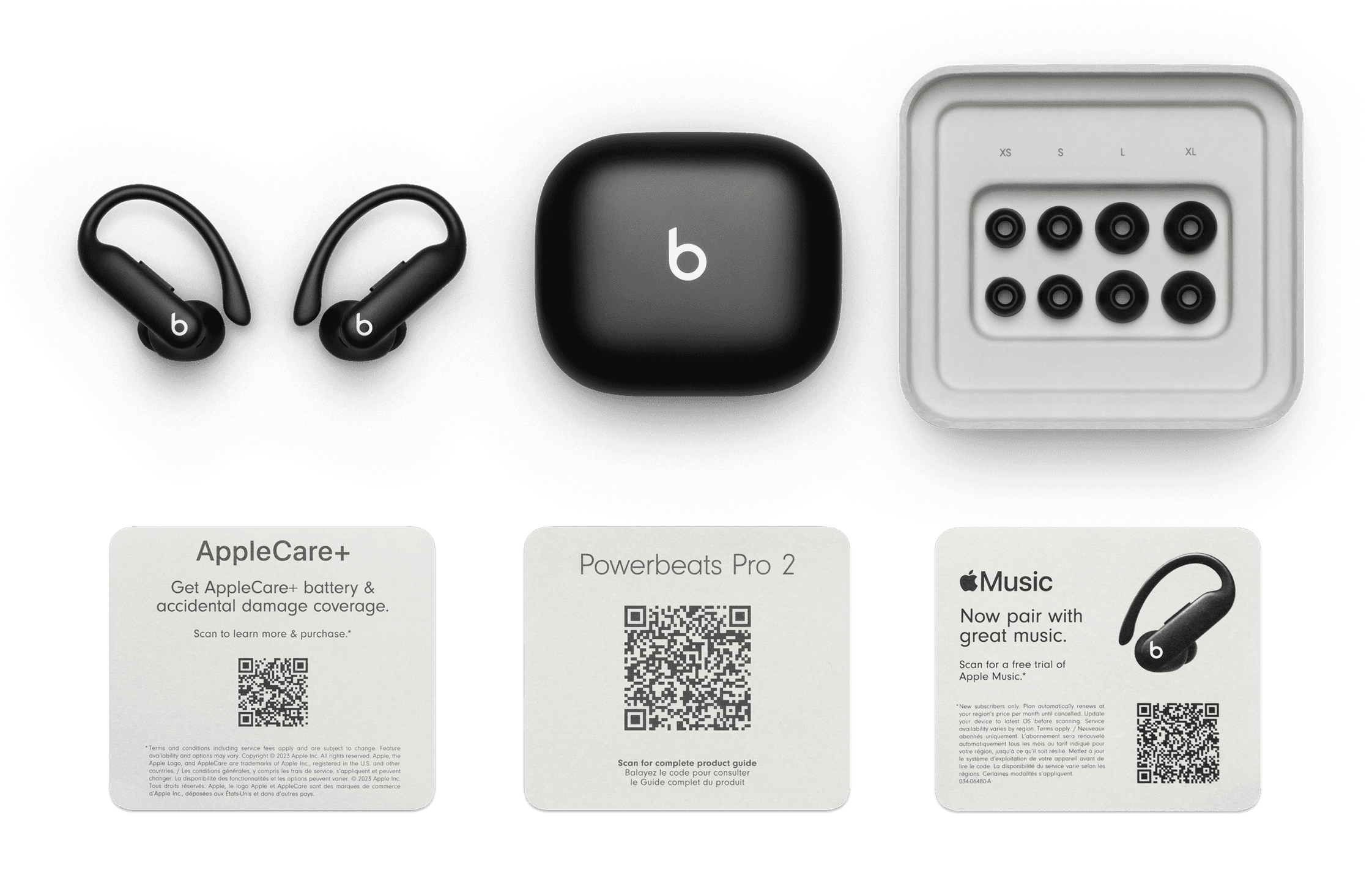 Jet Black Powerbeats Pro 2 earbuds, the closed charging case and a tray of spare silicone ear tips in sizes XS, S, L and XL