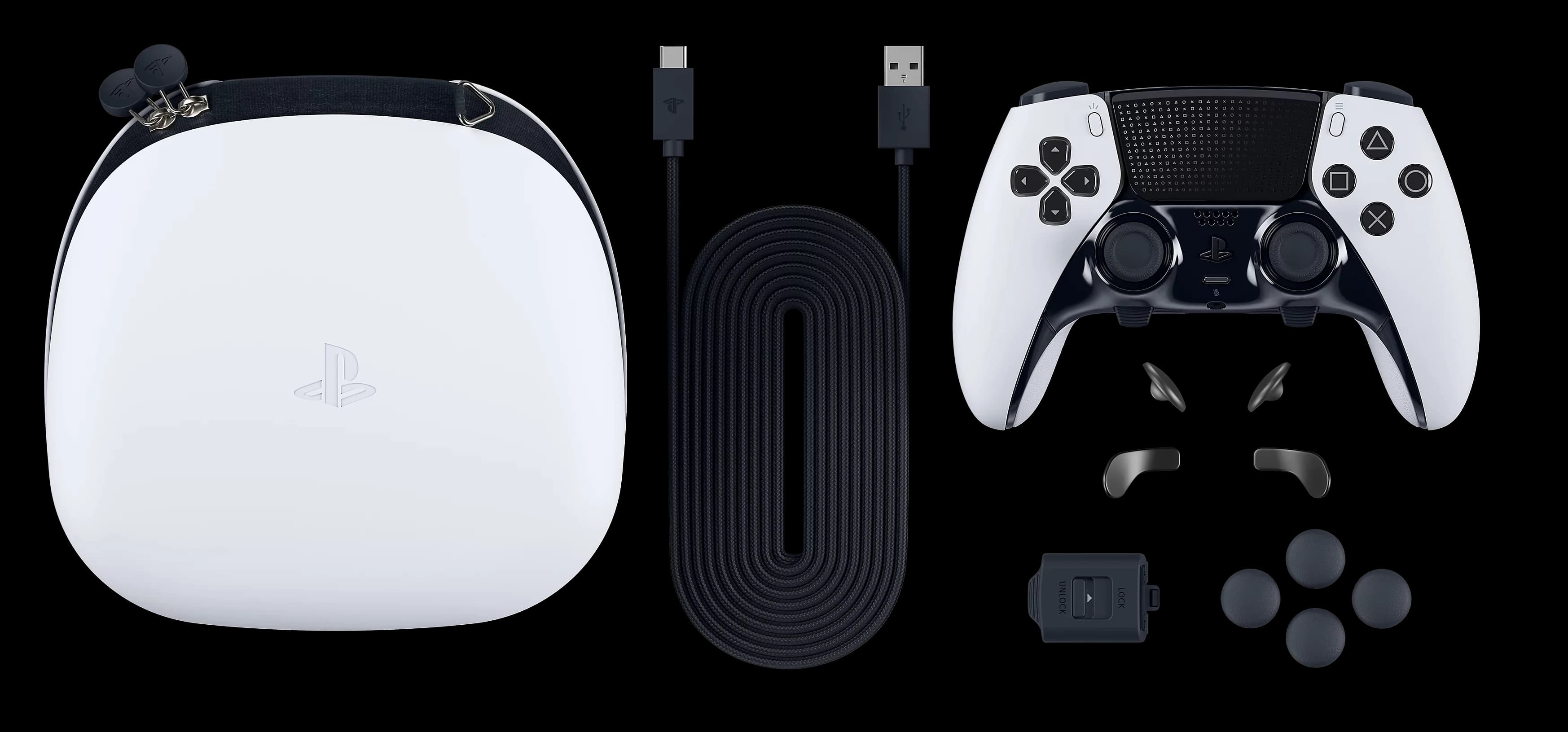 White DualSense Edge wireless controller laid out with its carrying case, braided USB cable, stick caps, back buttons and connector housing