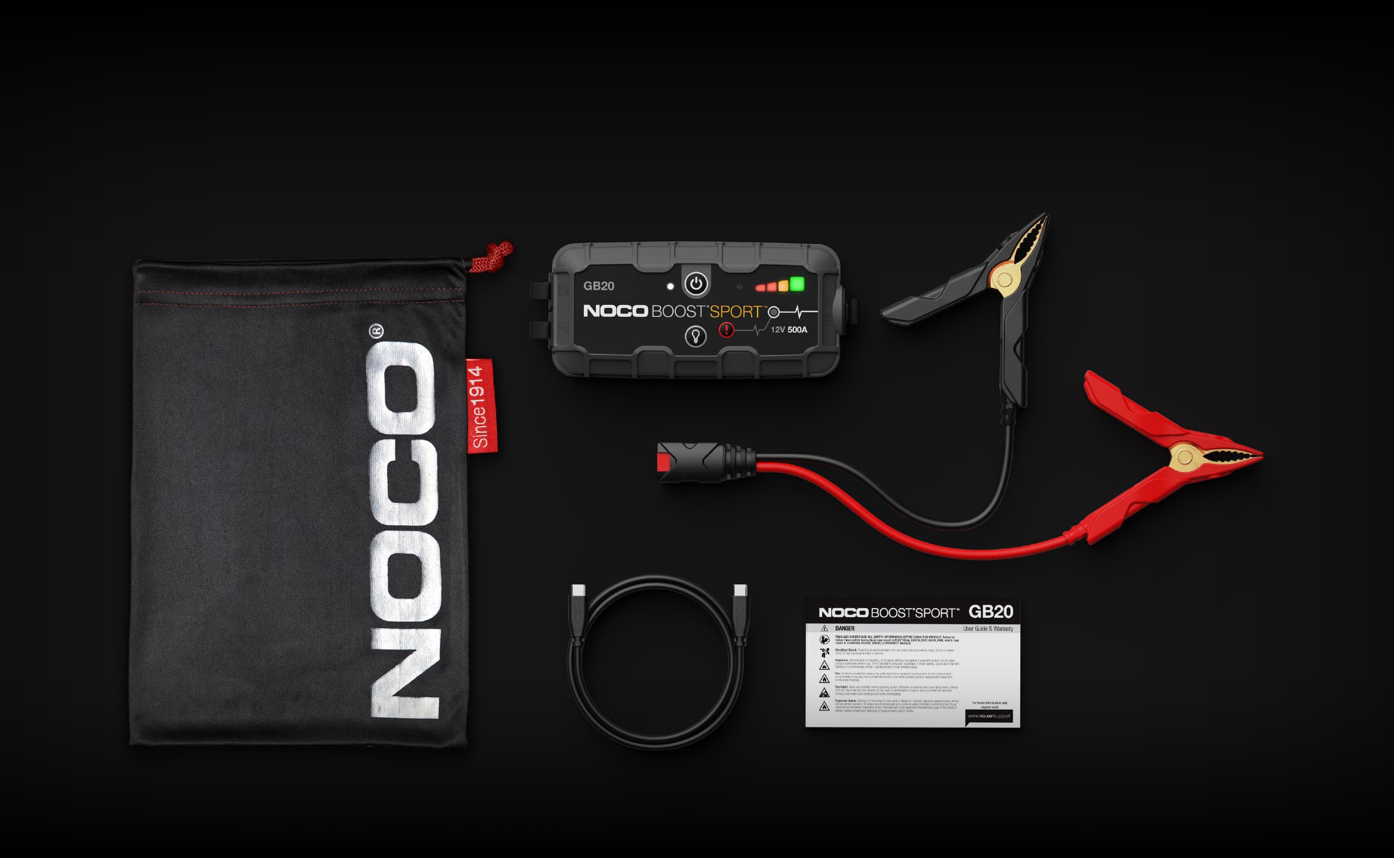 NOCO Boost Sport GB20 laid out with its clamps, USB-C cable, storage bag and safety and warranty leaflet