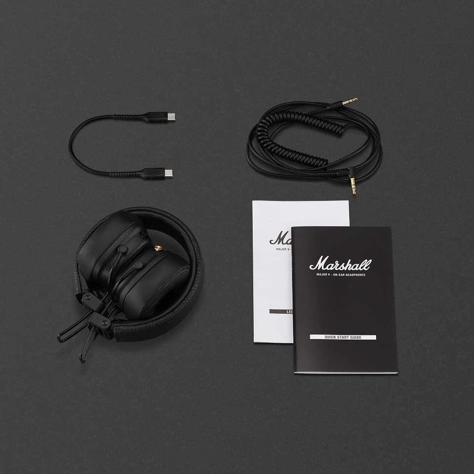 Major V headphones folded, with a coiled 3.5 mm audio cord, a USB-C charging cable and the printed user manual
