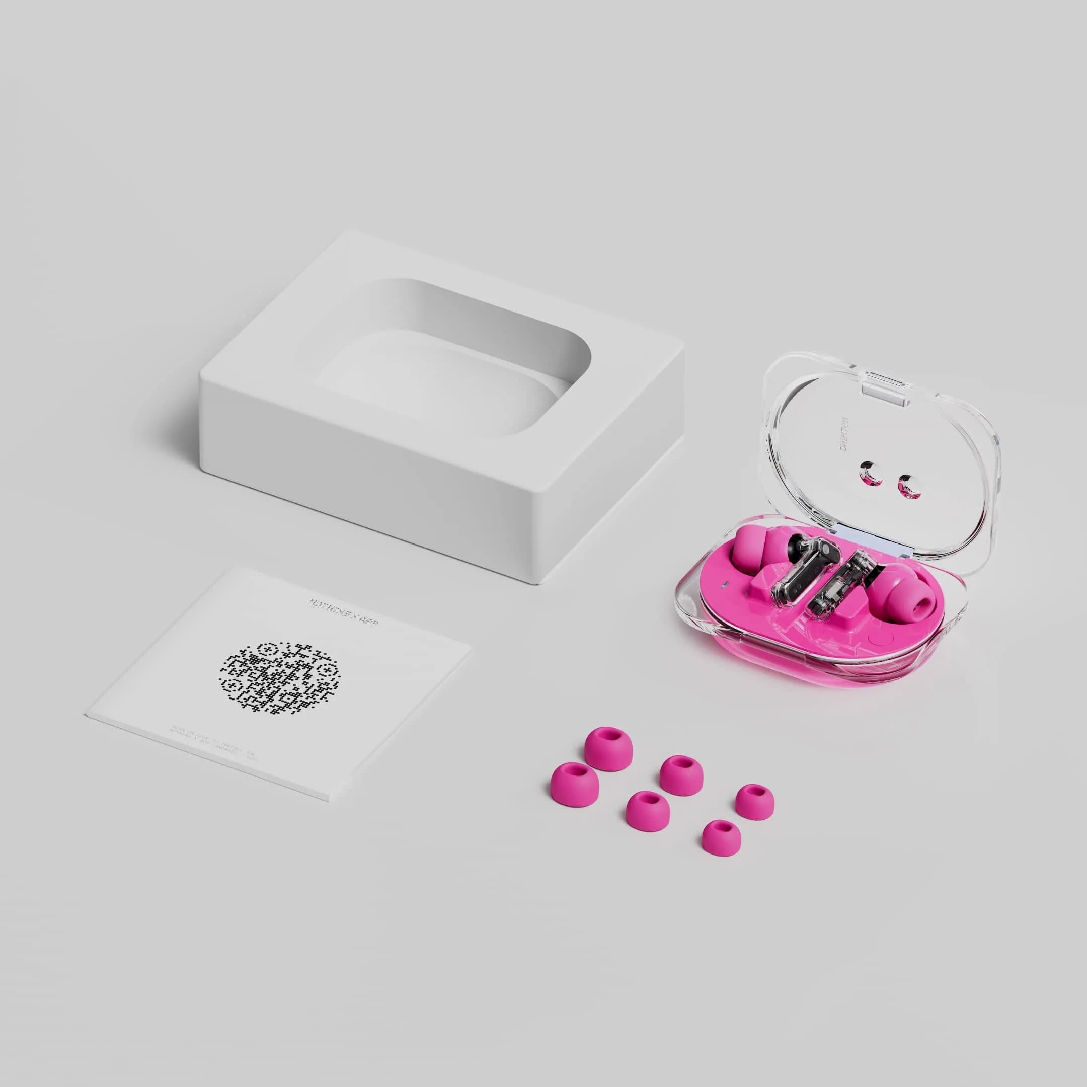 Nothing Ear (3a) box contents: the earbuds in their open transparent case, spare ear tips, the packaging tray and a printed card
